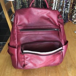 A red backpack purse, lots of room inside 💜